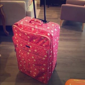 Large pink polka dot suitcase.